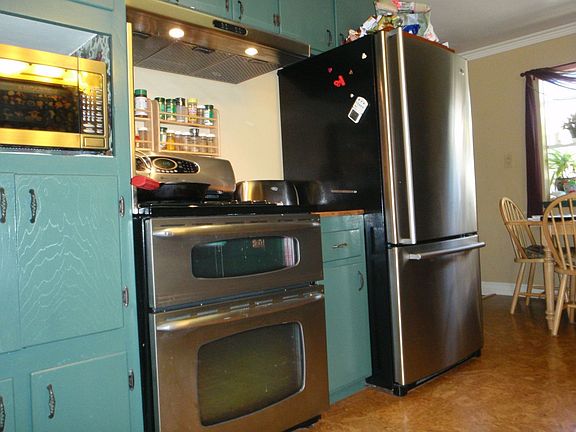 Kitchen with newer stainless steel appliances & cork floor