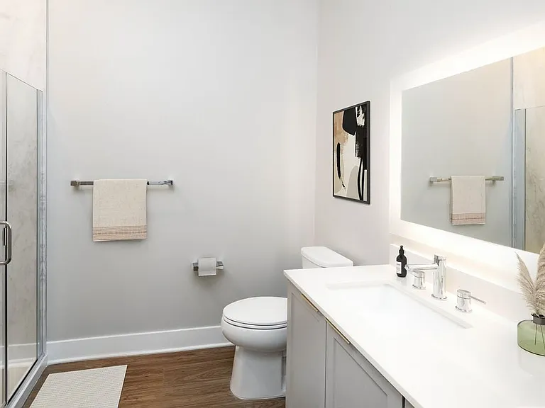 Signature Collection bath with white quartz countertop, backsplash, and hard surface flooring