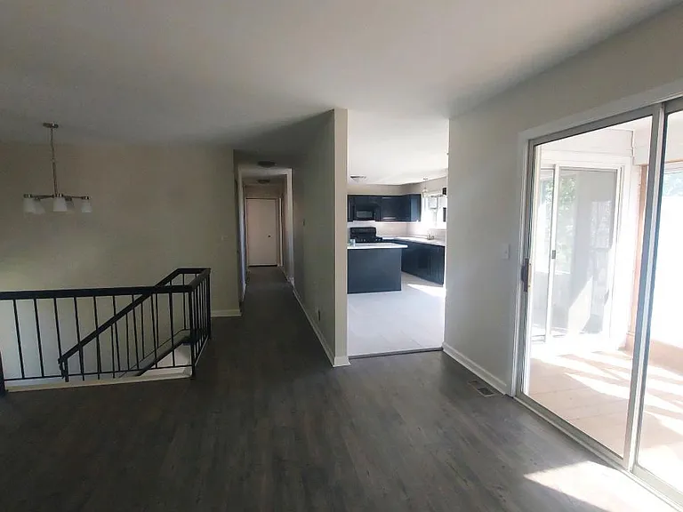 From living room looking into hall way to bedrooms , kitchen and sunroom (to the rt side door of the pic).