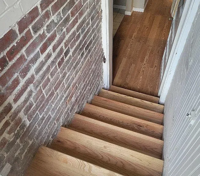Stairway to lower level. Washer/dryer area is on the left. Storage to the right of staircase.