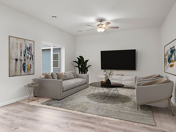 The family room is spacious with a ceiling fan.