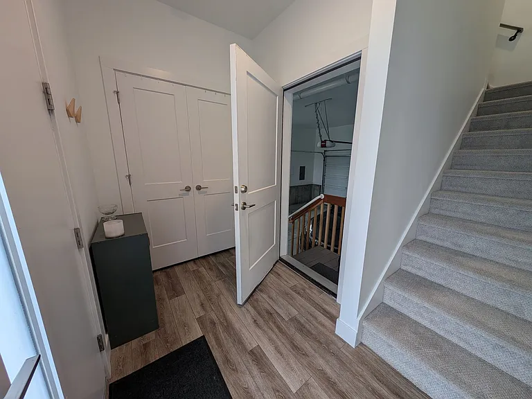 Entryway with storage closet and garage access