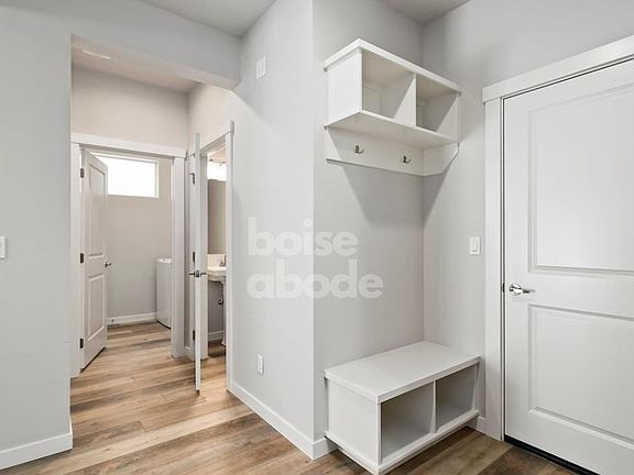 This convenient mud room provides a place to hang coats, backpacks, and bags.