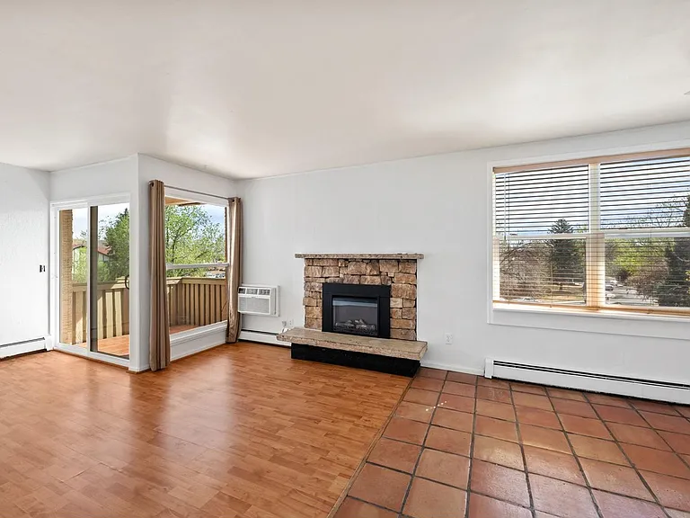 Main floor living area with newer electronic fireplace.
