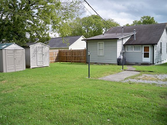 Large Back Yard with 2 Storage Buildings & Lighted Driveway