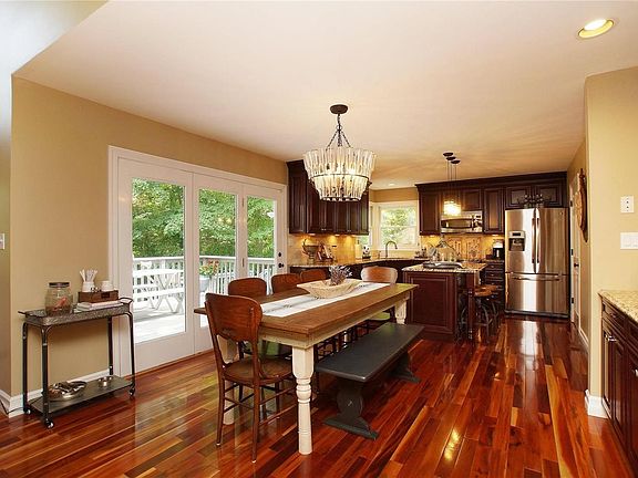 Breakfast Room With Unique Pottery Barn Chandelier & Trois French Doors Leading To Deck - Newer Refrigerator Stays