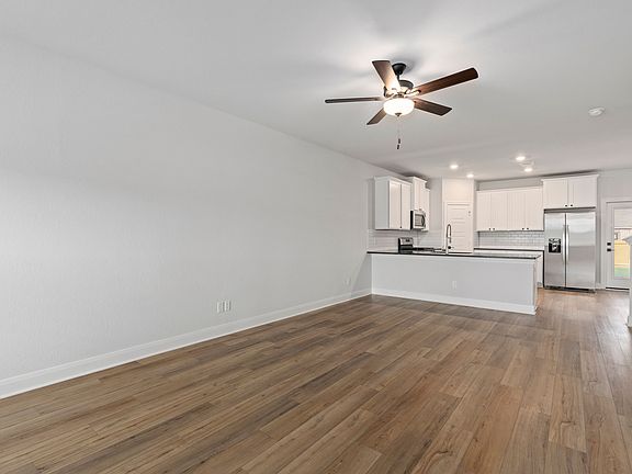 Open-concept layout with a spacious living room connected to the kitchen.