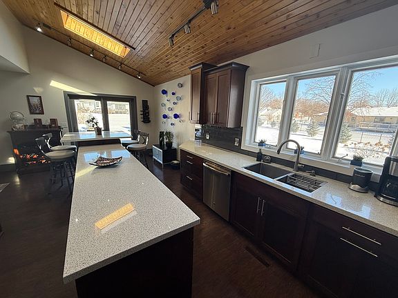 Kitchen view towards the island and patio door to the deck
