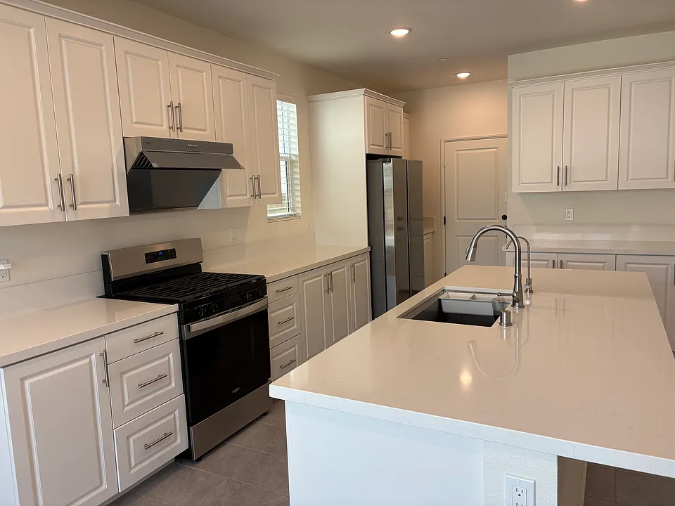 beautiful white quartz counters with brand new stainless steel appliances