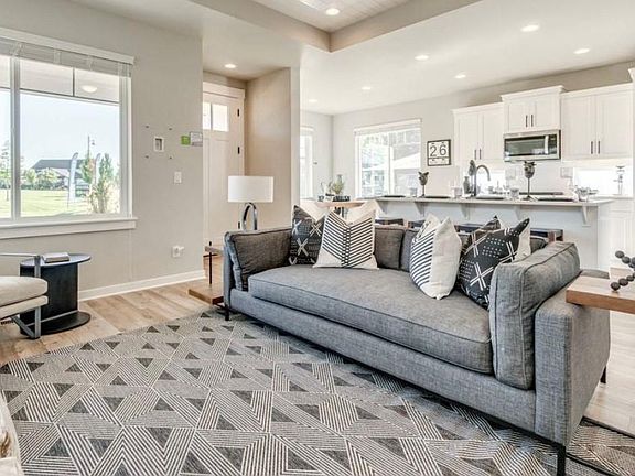 Staged Living Room with view of Entry and Kitchen. Representative only. Home is not rented furnished. Finishes may vary slightly.