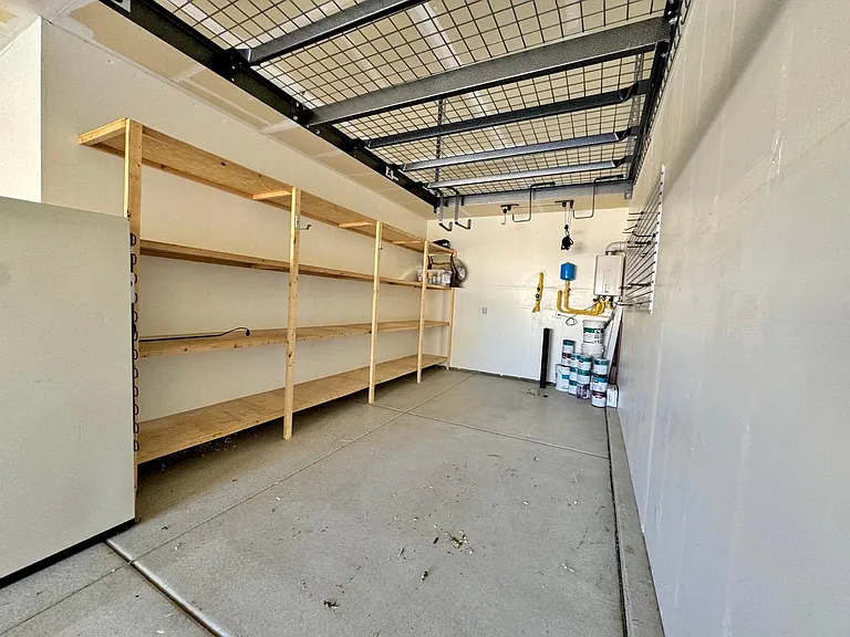 Tandem 3 car garage with built in storage shelves and slat wall