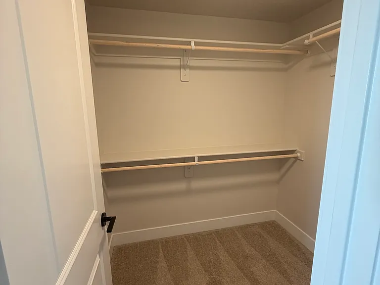 The upstairs primary suite offers a private and spacious retreat, complete with a large walk-in closet and a full en-suite bathroom. Thoughtfully designed for comfort and convenience.
