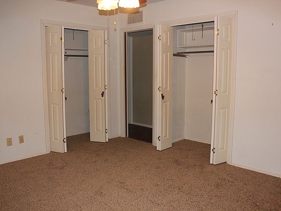 Master bedroom with his & her closets