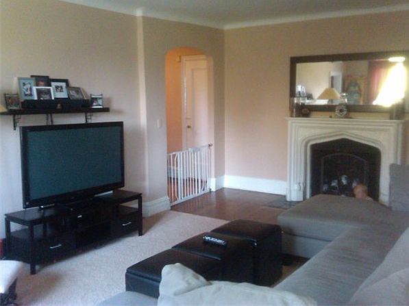 Spacious living room with working fireplace and lots of natural light