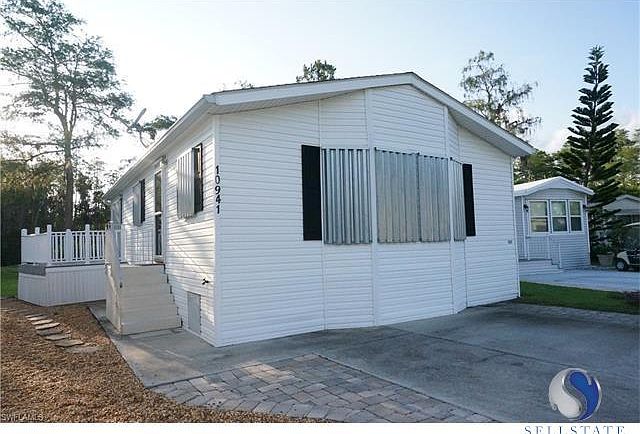 Front includes extra parking space and hurricane shutters throughout. Side balcony has a water view and sliders convenient to the den and kitchen.