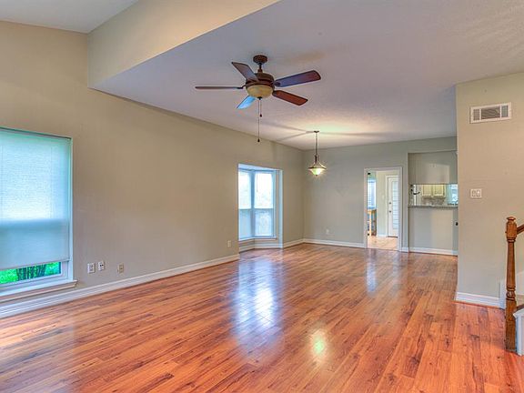 Gleaming wood floors and a nice neutral paint .