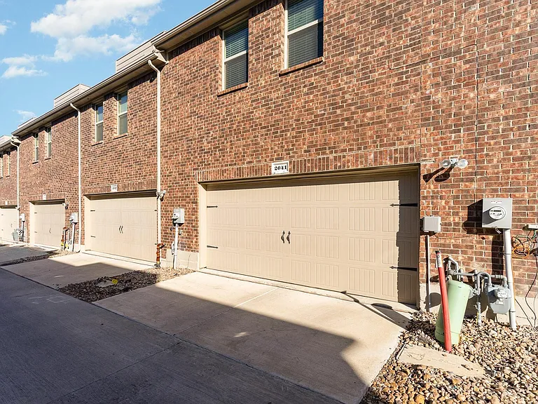 Rear entry garage with openers enters into kitchen