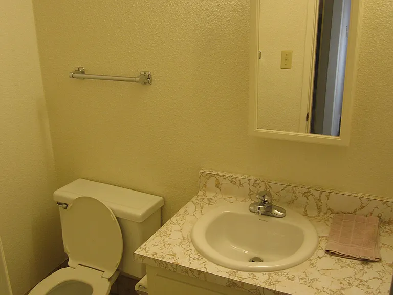 Downstairs bath to right of entry hallway.