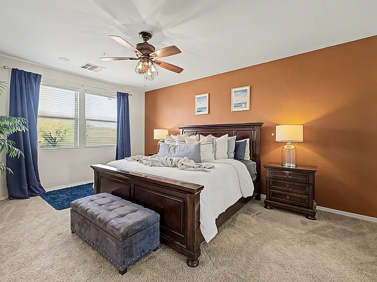 The spacious primary suite offers beautiful views of the mountains and overlooks the backyard and pool, creating a peaceful and relaxing retreat.