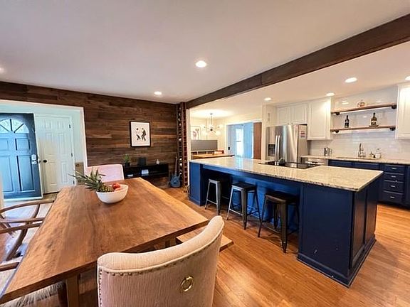 kitchen island and view of built of wine rack and built in bench seating with picnic style table