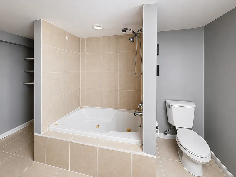 Bathroom showing jacuzzi tub + toilet