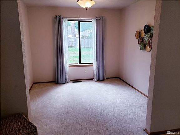 The dining room has a vented window that looks out to the private back yard.