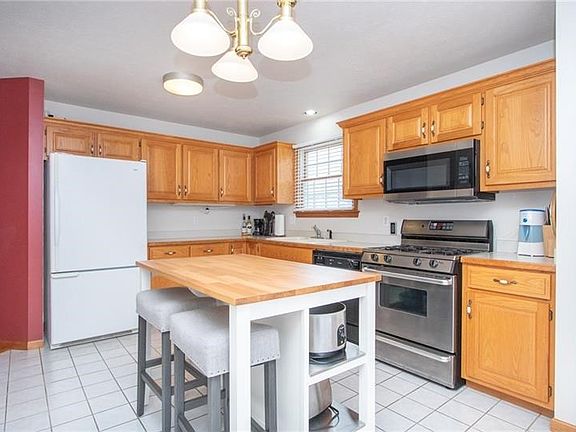 The spacious kitchen includes an island w/seating, good cabinet & counter space plus a large pantry.