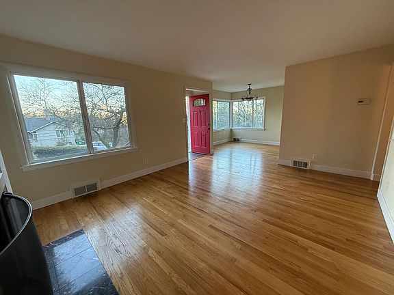 Living room looking at front door and dining room.