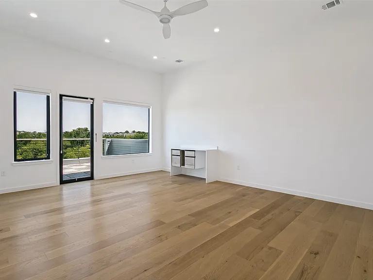 Second primary bedroom with en suite full bathroom and walk in closet. This space would be perfect for multi-generational or game/media room! Has access to deck with pergola. (3rd floor)