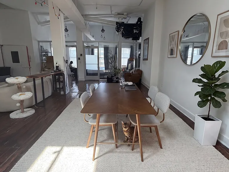 DINING ROOM TABLE WITH POOL TABLE BEHIND IT BEING PUT IN