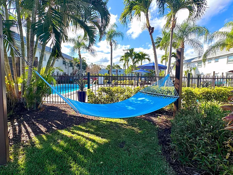 Enjoy the ultimate relaxation in a shaded hammock with a perfect view of the sparkling pool.