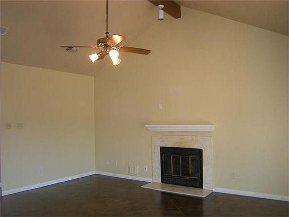 Family room with gas log fireplace & dramatic vaulted, beamed ceiling