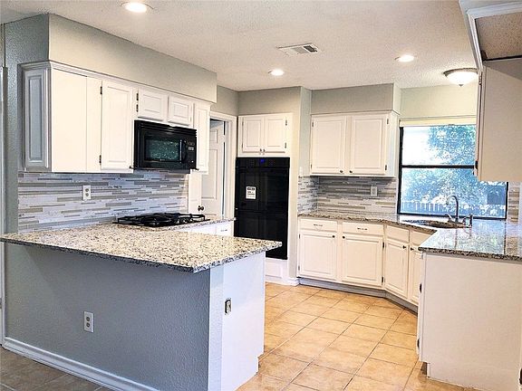 *UPDATED PICS COMING SOON*
View from breakfast nook into kitchen
- Granite countertops
- Dual ovens
- Gas range
- Fridge included (not pictured)