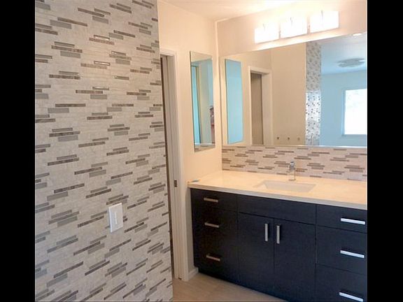Master bath has new cabinets and designer tile.