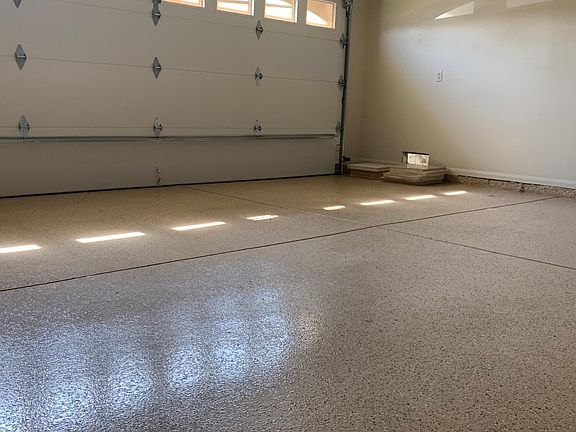 Spacious garage with automatic opener and epoxy flooring