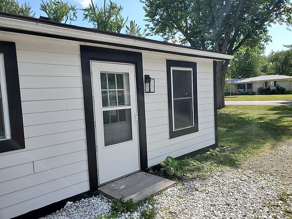 ENTRANCE ON THE SIDE W/ UPDATED SIDING AND LIGHT FIXTURES