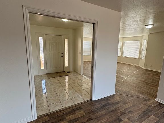 entry way with view of front door and livingroom with pocket doors open