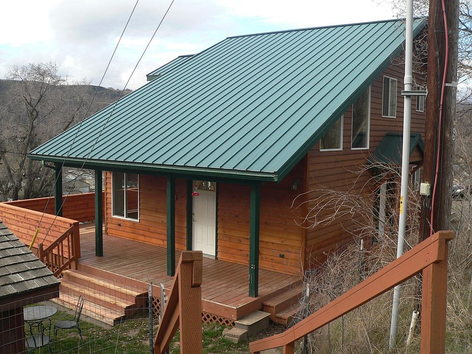 East side of house with porch and yard access.