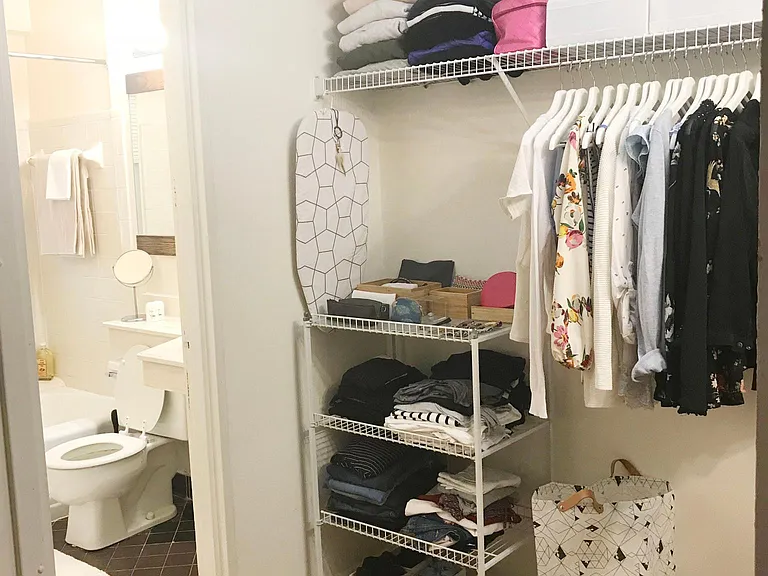 Walk-in closet with view of the bathroom