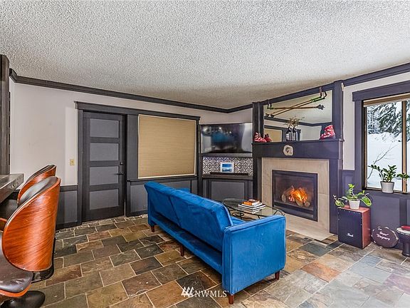Gorgeous slate floors and gas fireplace. The door goes out to patio #1.