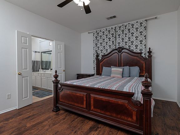 Primary bedroom with king size bed and attached primary bathroom.