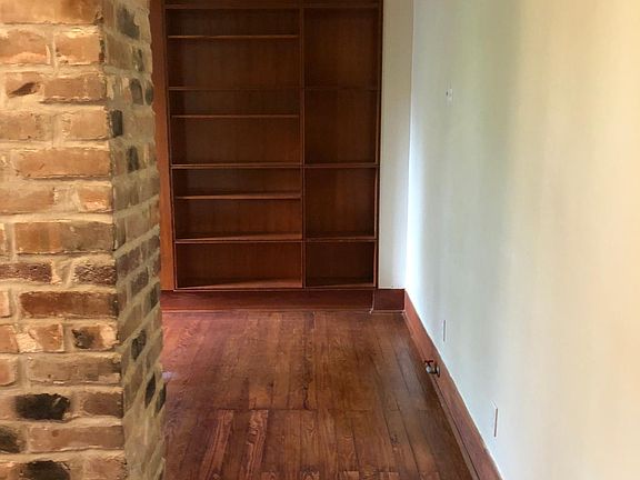 View as you enter the door into the living area with a full wall of bookcases in the living area.