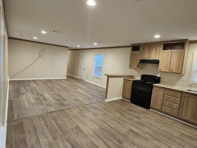 View of open concept kitchen with spacious living room area, and dining area.