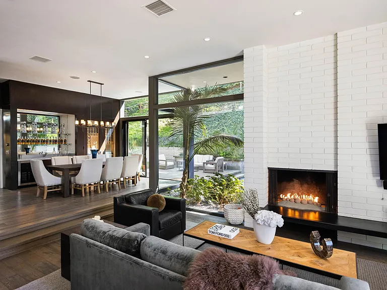 Cozy up by the fireplace, adding warmth and ambiance to the living space for a relaxing evening indoors.