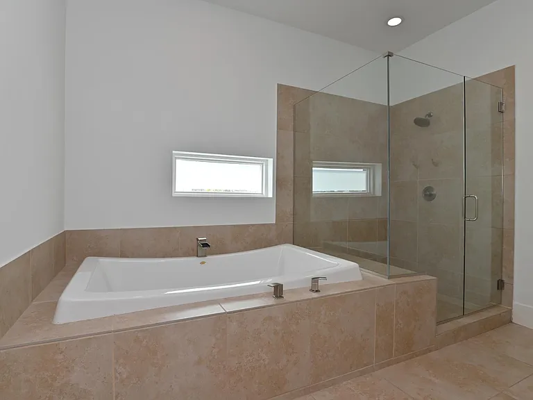 Huge soaker tub is big enough for 2 and large shower.