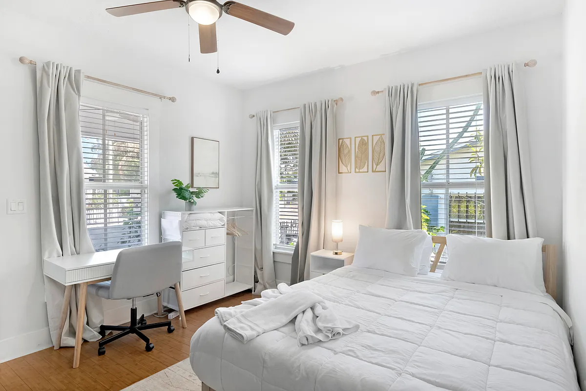 Queen sized bed with designated work desk in bedroom - 1825 E 4th Ave