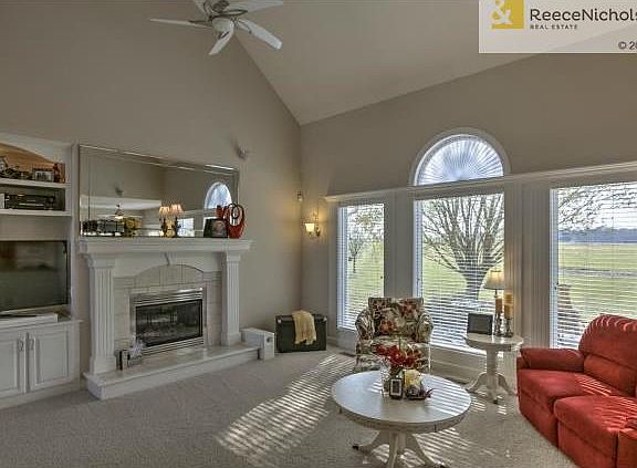 Vaulted ceilings in living room with a wall of windows. Useful b