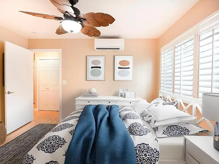 Bedrooms with wall mount air-conditioning, decorative fans, and shutters