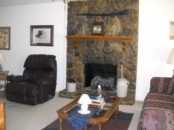 Den with hand-laid stone fireplace with gas logs