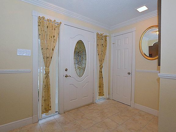 A formal entry foyer introduces the home. The home features extensive crown molding.
